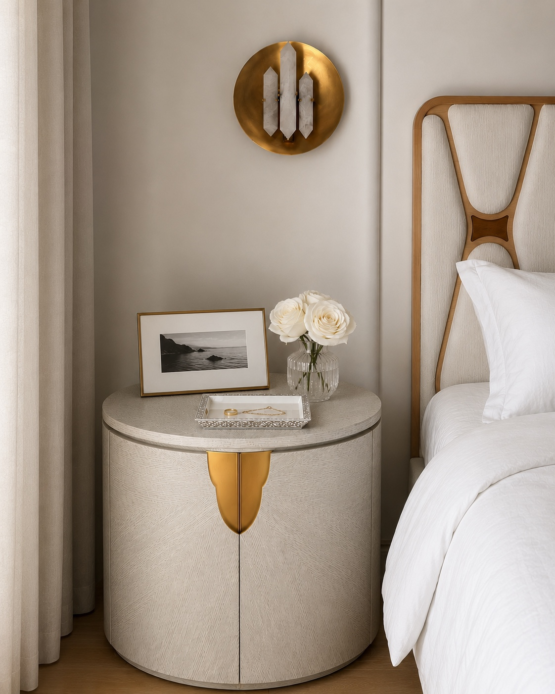The curved bedside wall and recessed headboard, finished with warm wood and brass.